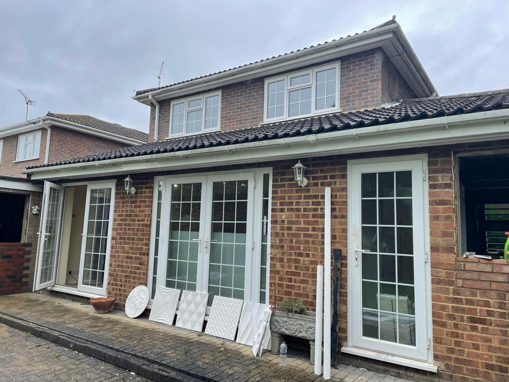 Professional building contractors working on residential construction site with tools and blueprints